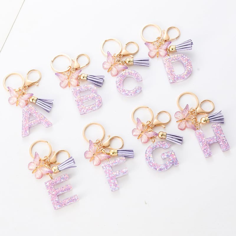 Pendentif lettre papillon Kuschelwohl™ avec pompon – Coloré et personnalisé (Vente de Noël 🎄)